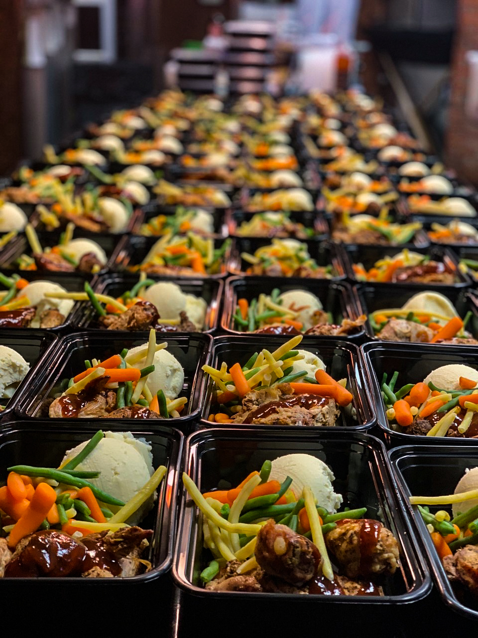 Rows of chef-prepared meal containers ready for distribution